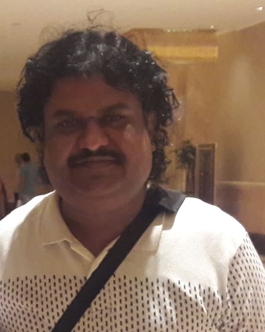 Colour photograph of Osman Mir in a white patterned shirt, Abu Dhabi, September 2016