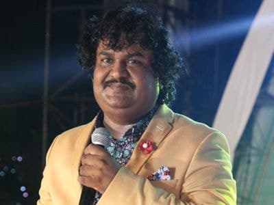 Colour photograph of Osman Mir singing on stage, USA, 2014